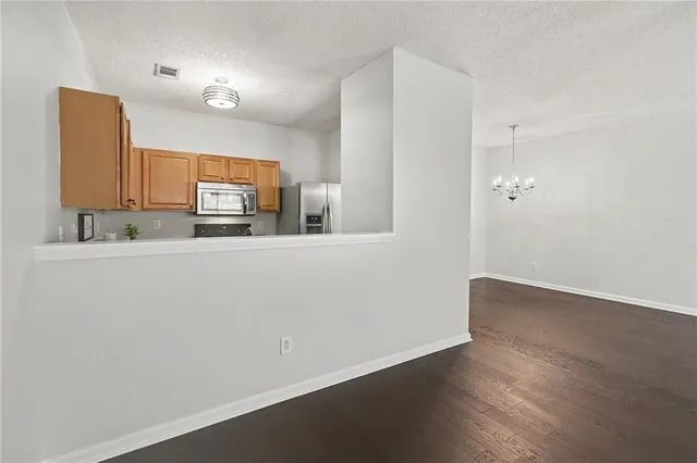 a kitchen with stainless steel appliances a refrigerator and a stove top oven