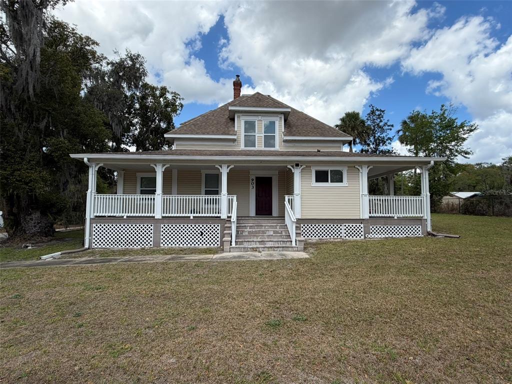 903 East New York Avenue DeLand, FL 32724 - Photo 1 of 29 a front view of a house with a garden