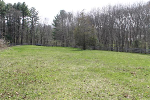 10 Old Common Road Sutton, MA 01590 - Photo 3 of 6 a view of a yard with a trees in the background