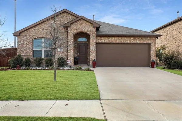 a front view of brick house with a yard