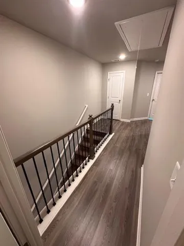 a view of hallway with wooden floor