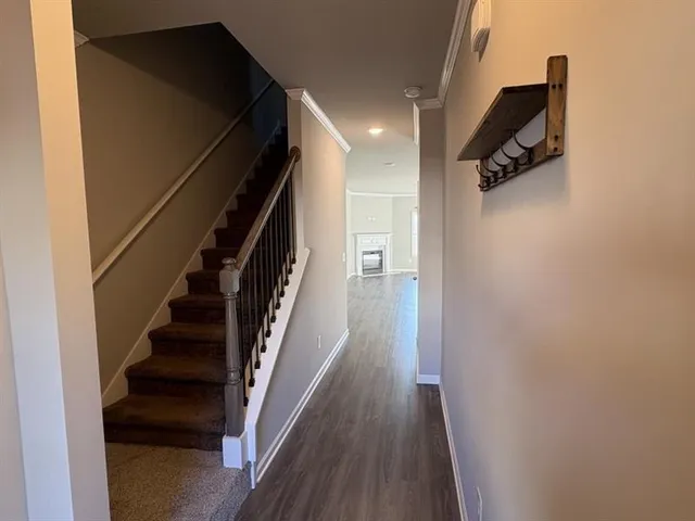 a view of hallway with stairs and wooden floor