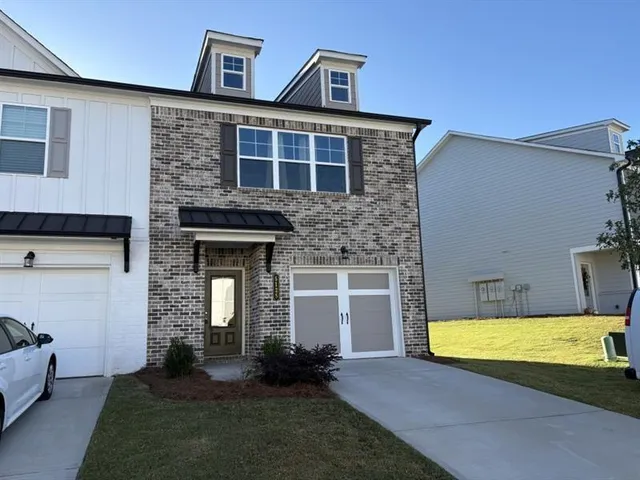 a view of a house with swimming pool in front of it