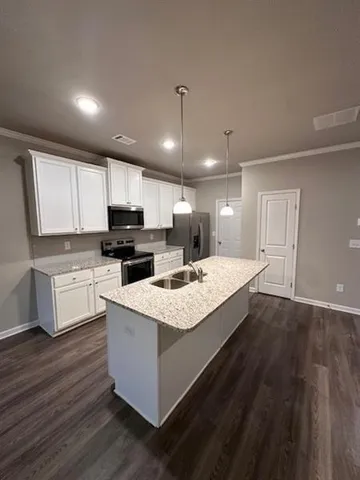 a large white kitchen with wooden floor