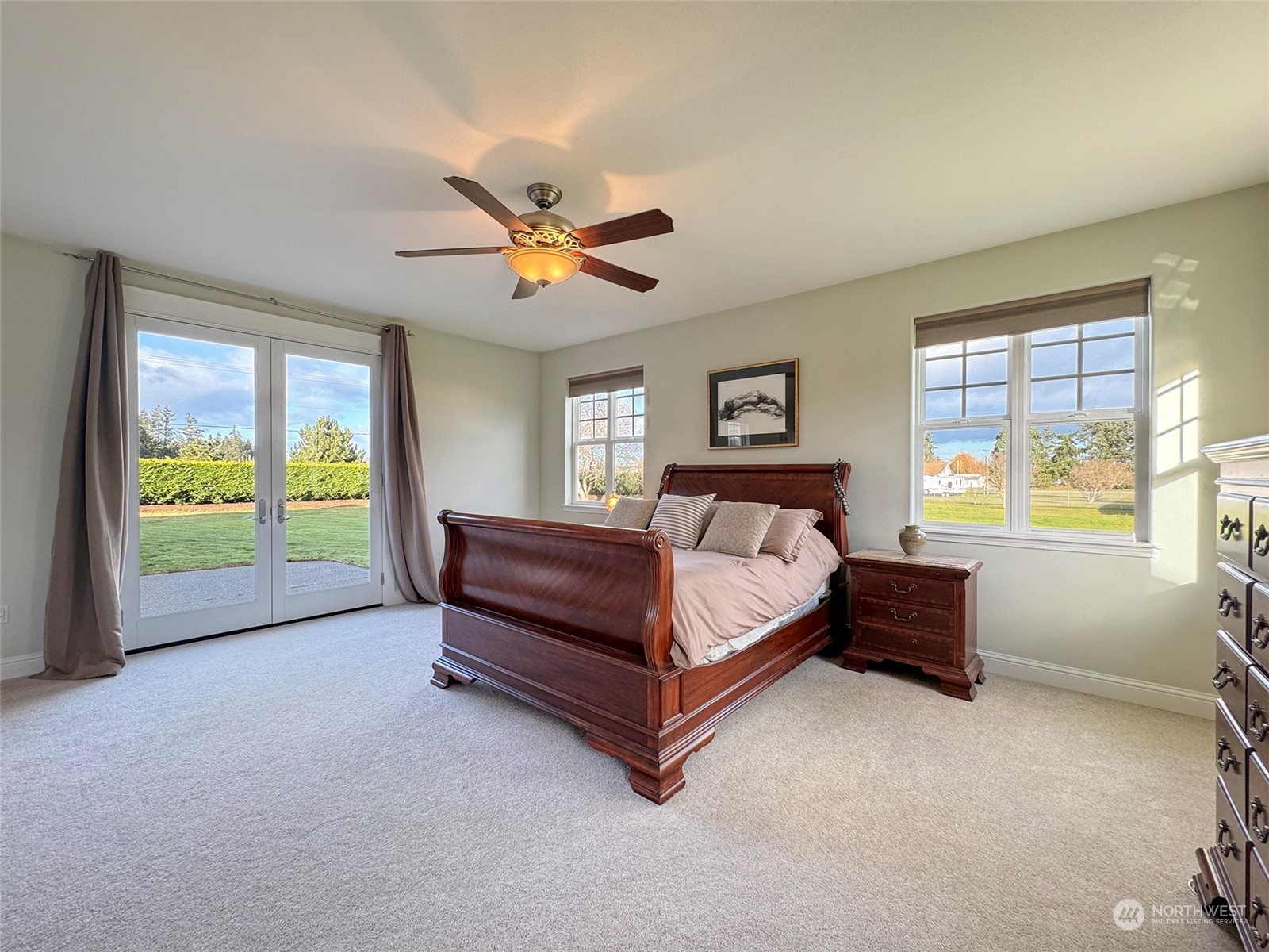 31 Fergy Lane Sequim, WA 98382 - Photo 16 of 40 a spacious bedroom with a bed and a chandelier