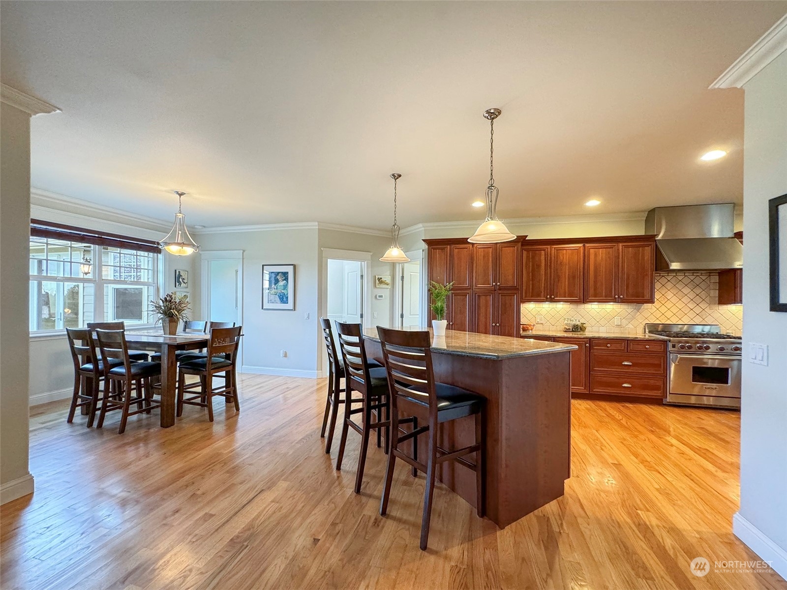 31 Fergy Lane Sequim, WA 98382 - Photo 9 of 40 a kitchen with stainless steel appliances granite countertop wooden floor a dining table and chairs