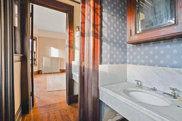a bathroom with a granite countertop sink and a mirror