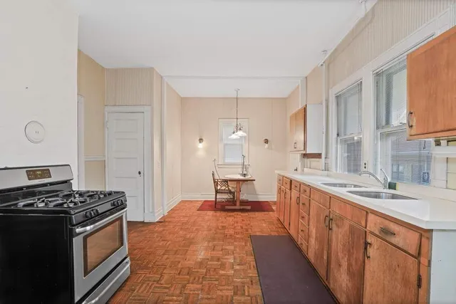a kitchen with stainless steel appliances a stove a sink and a refrigerator