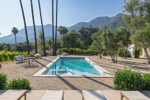 a view of a backyard with a table and chairs
