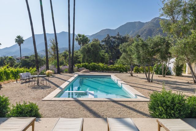 a view of a backyard with a table and chairs