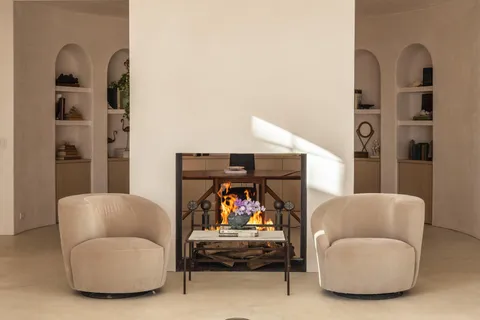 a living room with furniture and a mirror