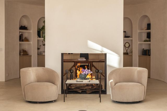a living room with furniture and a mirror