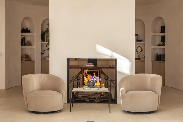 a living room with furniture and a mirror