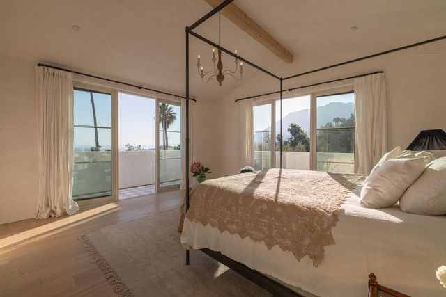 a bed sitting in a bedroom next to a large window