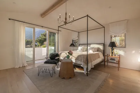 a bedroom with a bed and large window