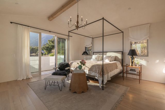 a bedroom with a bed and large window