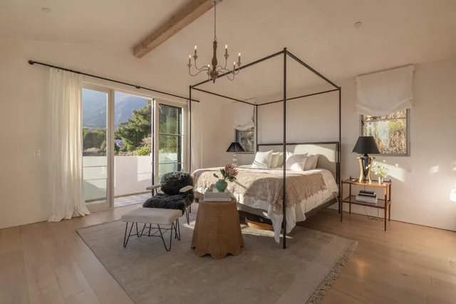 a bedroom with a bed and large window