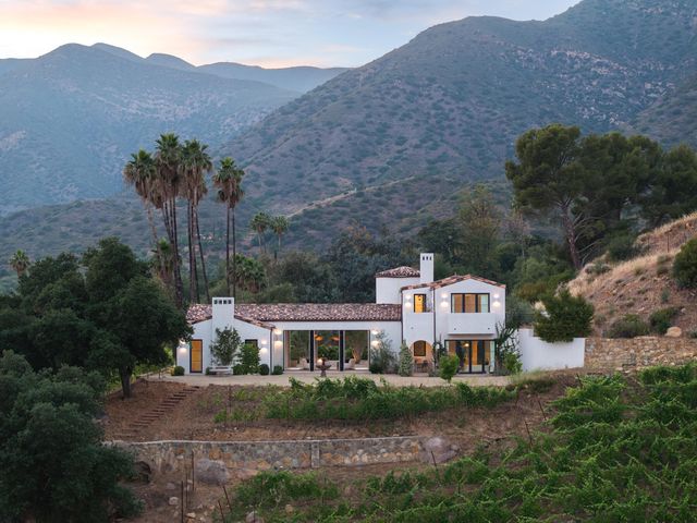 a view of a house with a garden and a yard