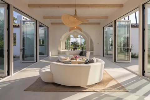 a view of living room with a large window and chandelier