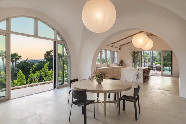 a view of a dining room with furniture wooden floor and a chandelier