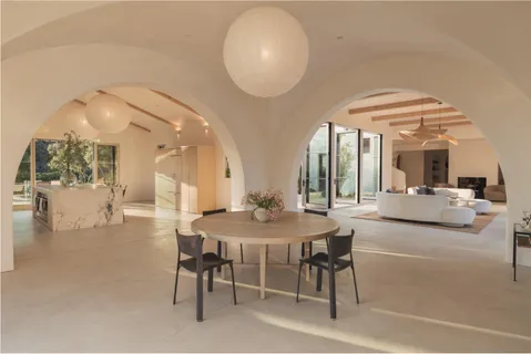 a view of a dining room with furniture and a chandelier