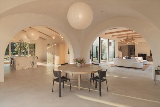 a view of a dining room with furniture and a chandelier