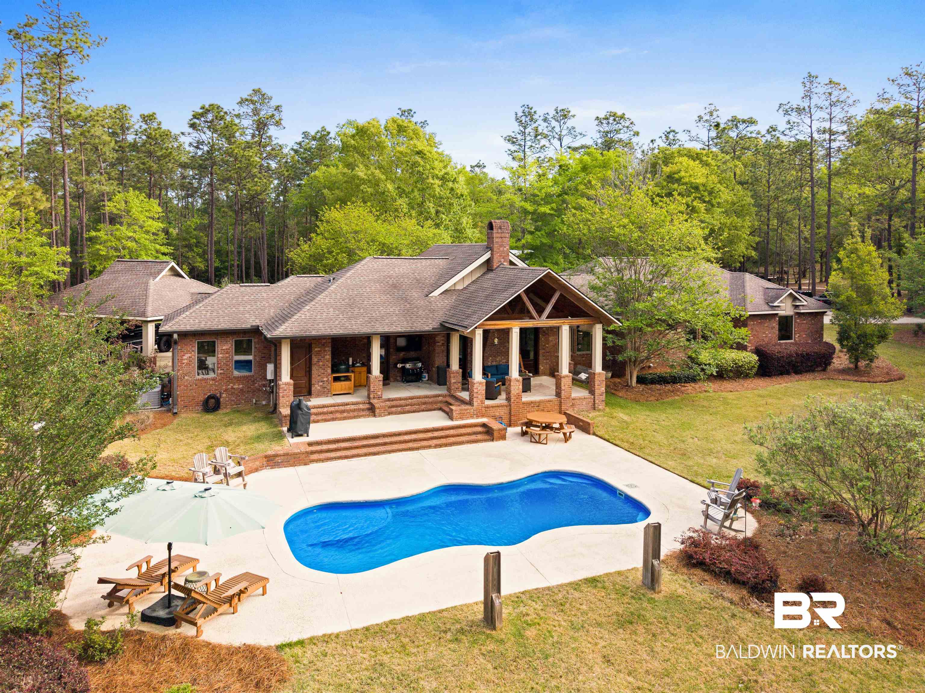 47252 Emmons Road Bay Minette, AL 36507 - Photo 6 of 50 Rear view of house with a lawn, a patio area, brick siding, a shingled roof, and a chimney