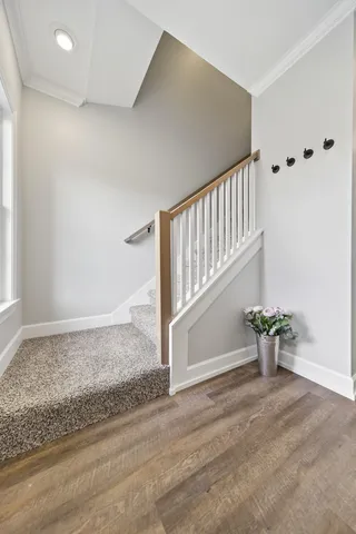 a spacious bedroom with a bed and a chandelier