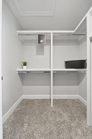 a spacious bedroom with a bed and a window