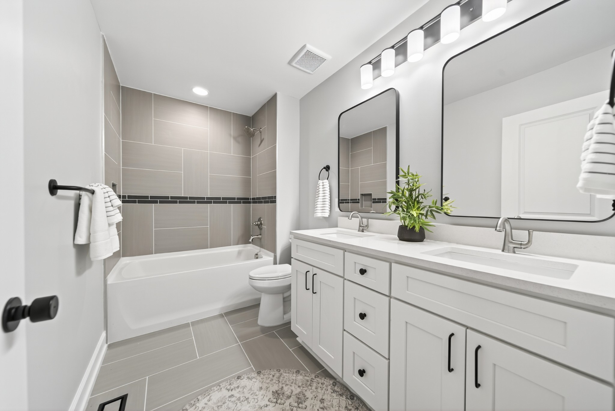 100 Maple View Drive Lebanon, TN 37087 - Photo 23 of 35 a bathroom with a double vanity sink a toilet a mirror and shower