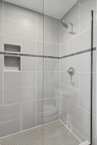 a view of a hallway with wooden floor and a potted plant