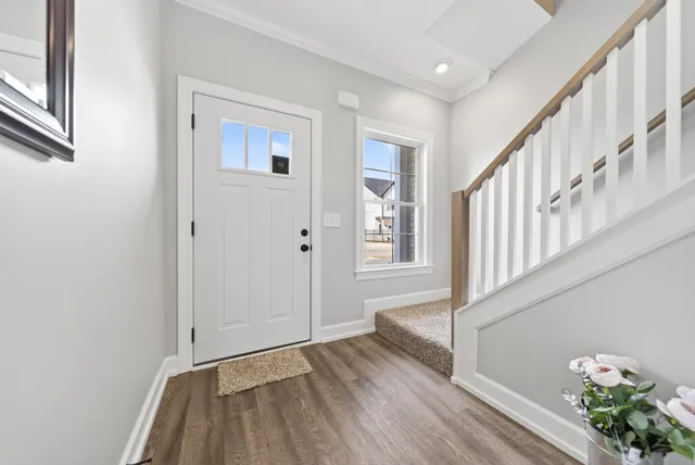 a view of an entryway with wooden floor