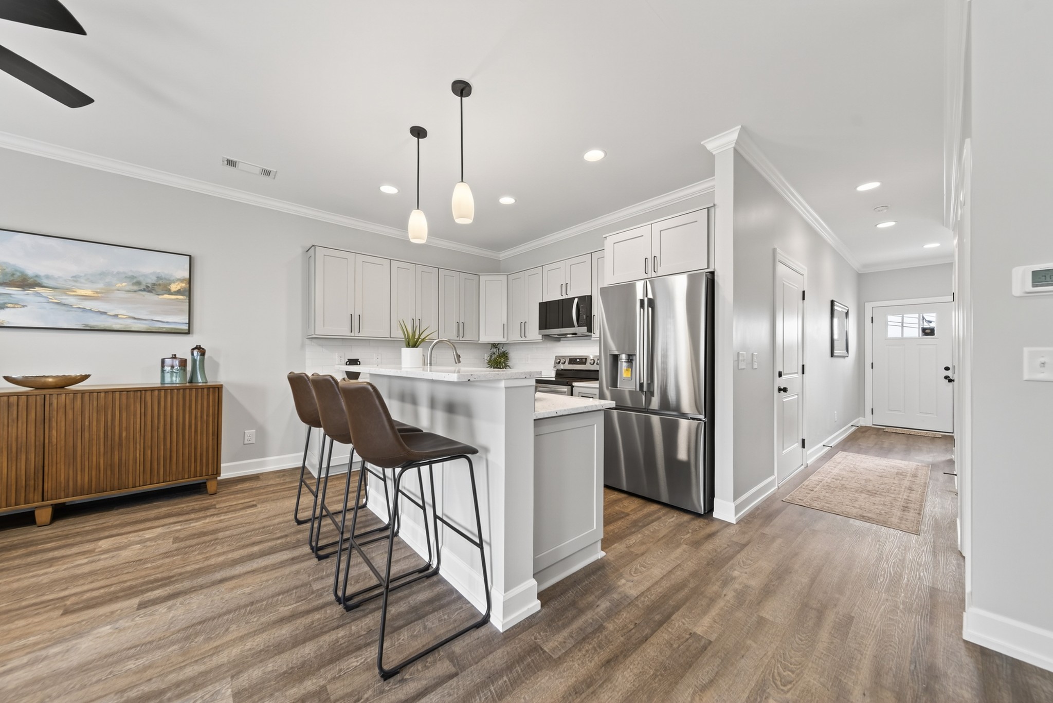 100 Maple View Drive Lebanon, TN 37087 - Photo 8 of 35 a kitchen with stainless steel appliances kitchen island granite countertop a refrigerator a stove a sink a dining table and chairs with wooden floor