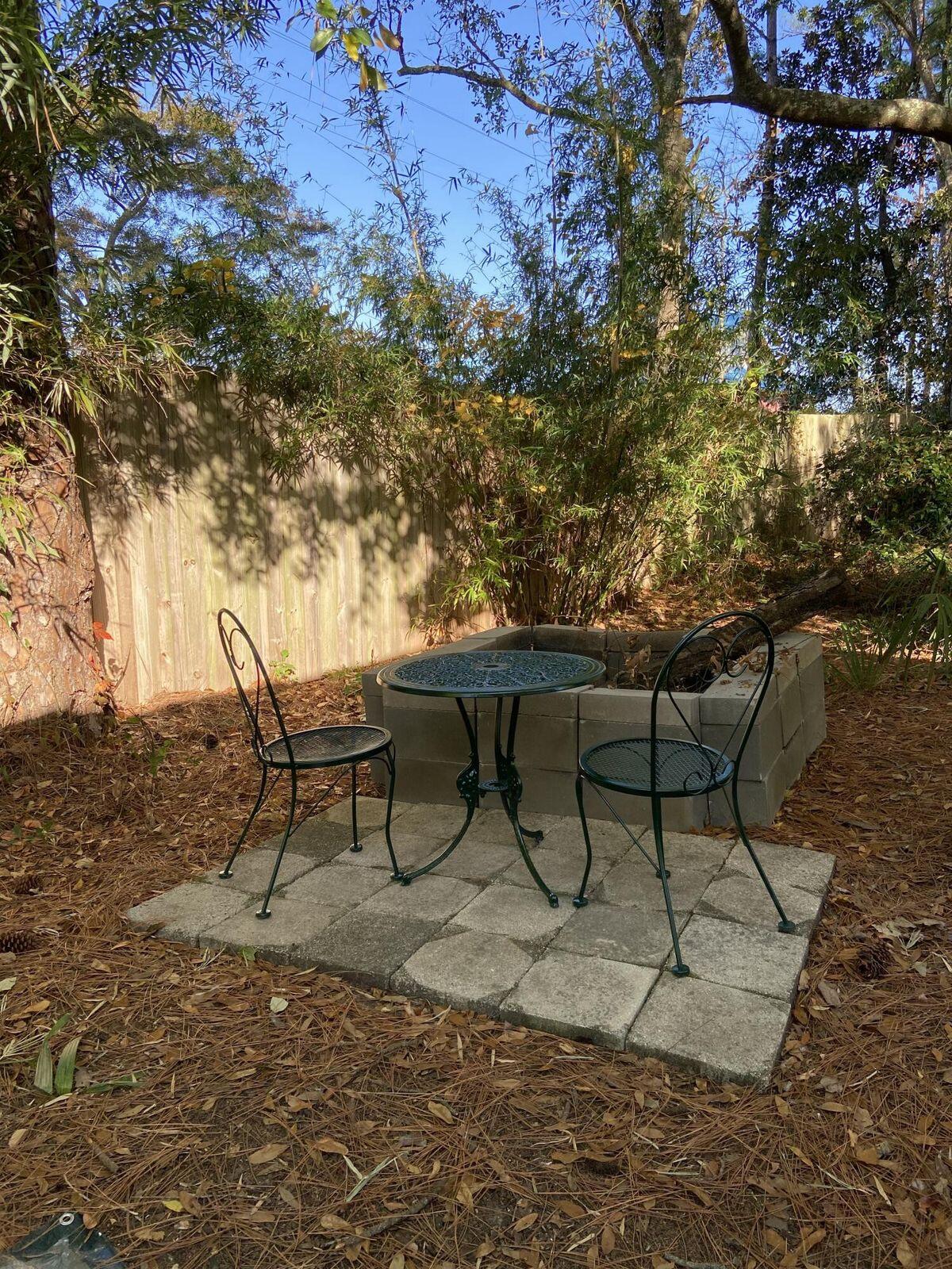 19 Plantation Way Santa Rosa Beach, FL 32459 - Photo 24 of 36 a couple of chairs and a table in a backyard