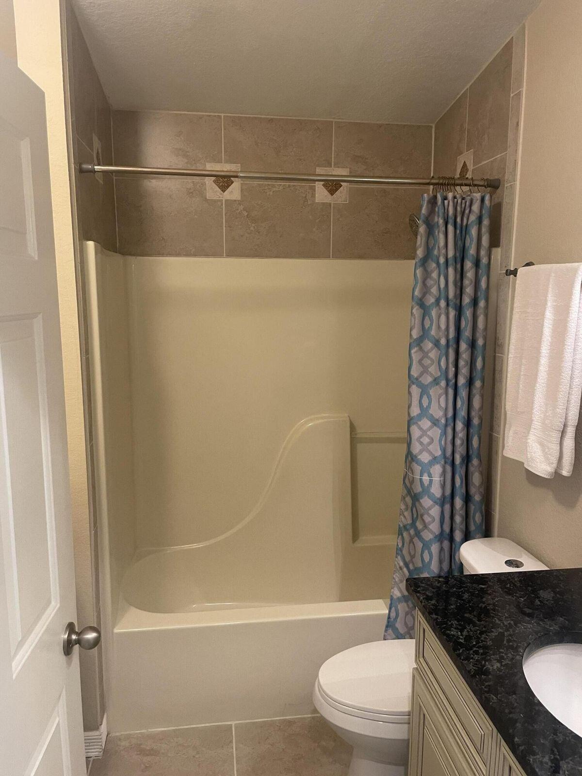 19 Plantation Way Santa Rosa Beach, FL 32459 - Photo 30 of 36 a bathroom with a granite countertop bathtub shower and toilet