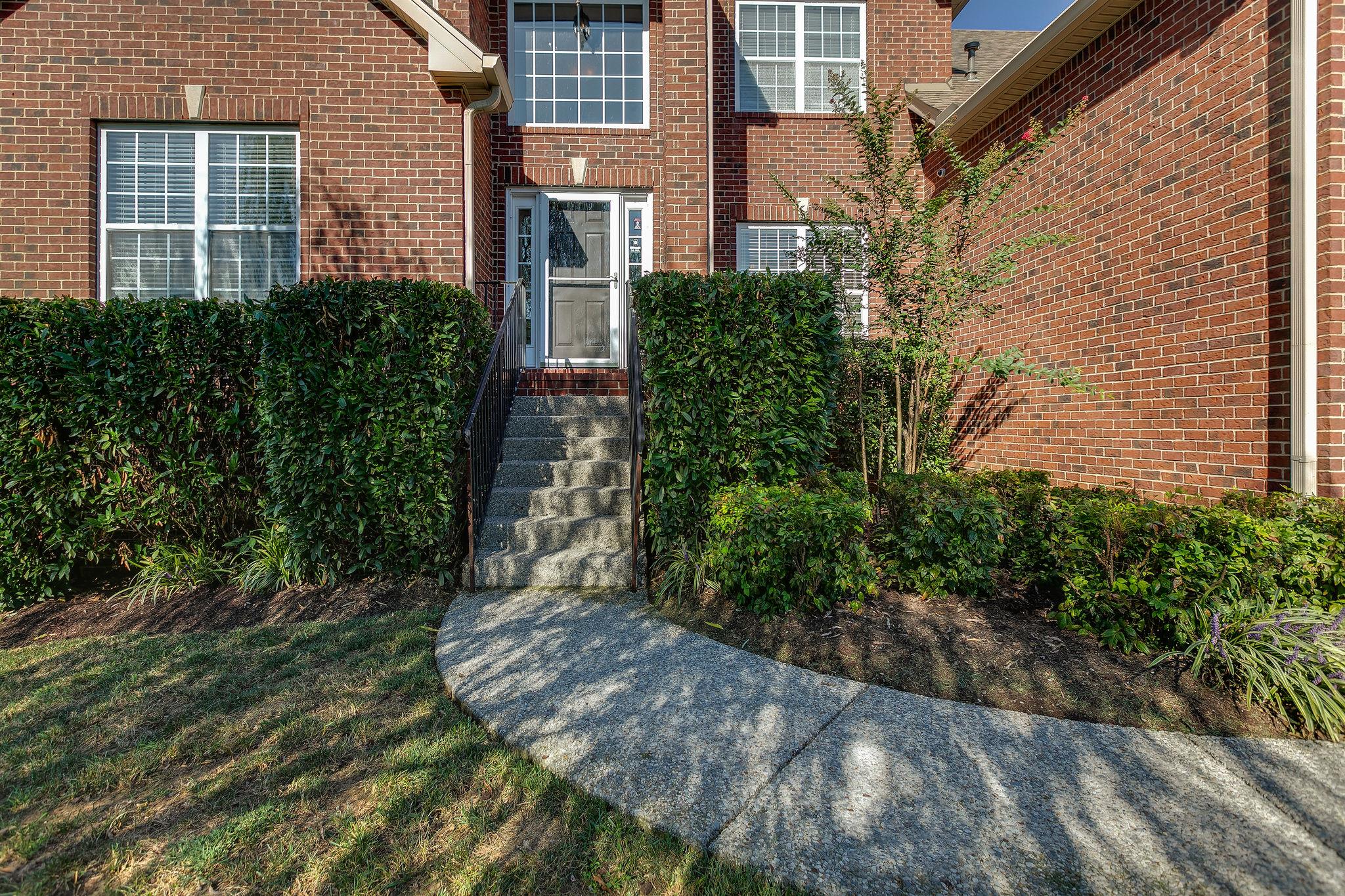 2029 Lincoln Road Spring Hill, TN 37174 - Photo 3 of 30 a view of a brick house with plants and trees