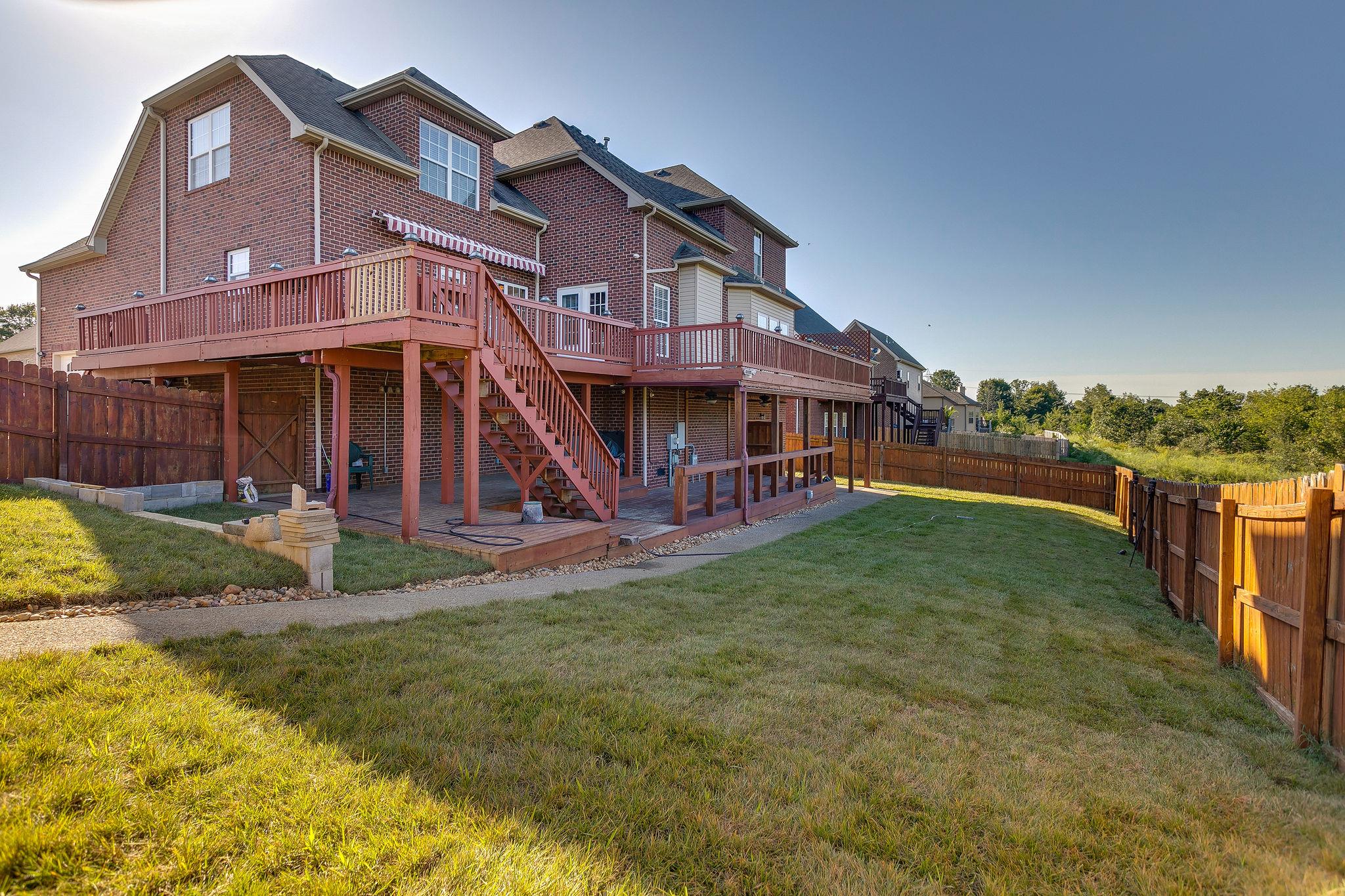 2029 Lincoln Road Spring Hill, TN 37174 - Photo 30 of 30 a view of a big house with a big yard and large trees