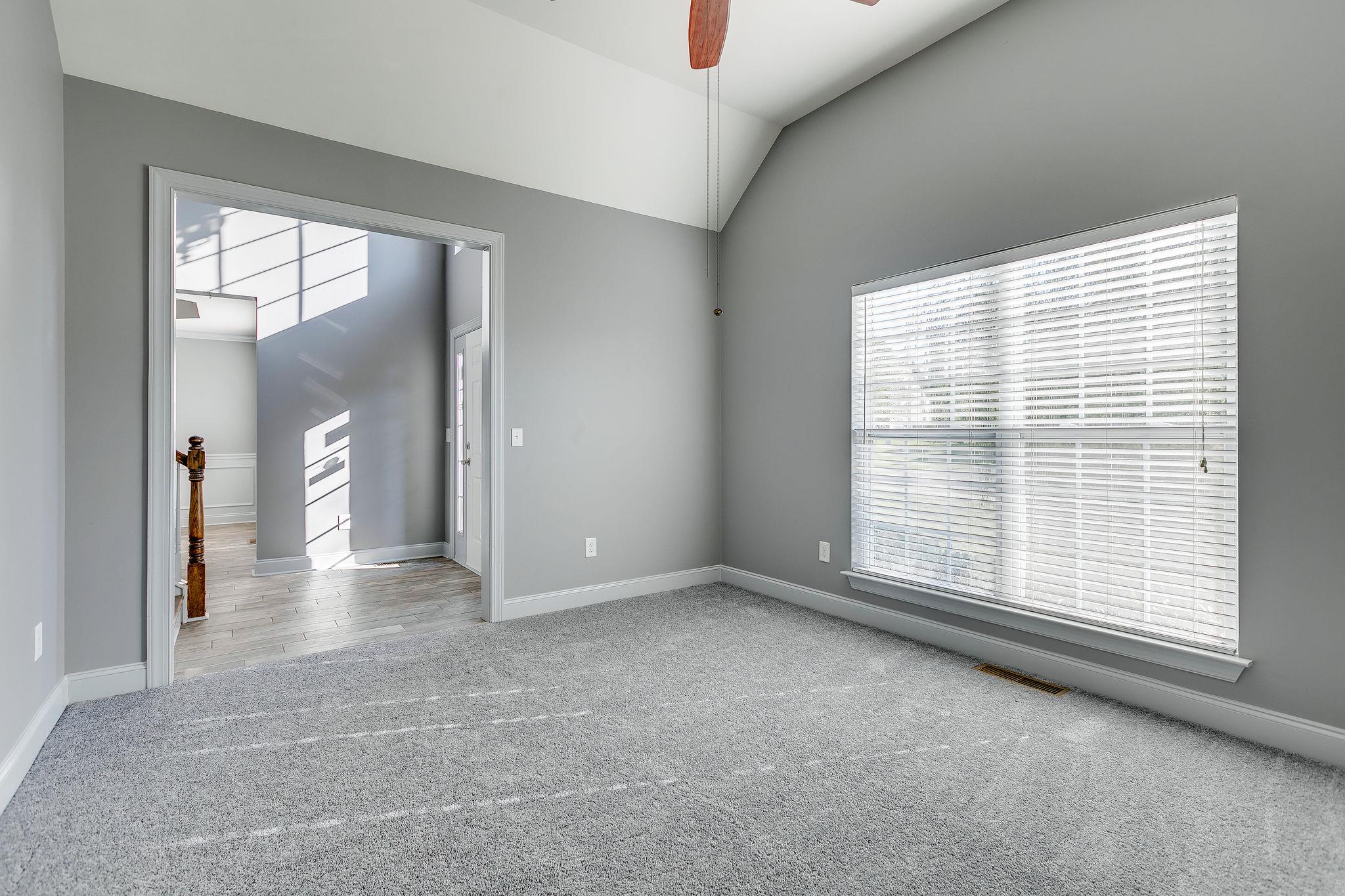 2029 Lincoln Road Spring Hill, TN 37174 - Photo 6 of 30 a view of an empty room with a window and a kitchen view