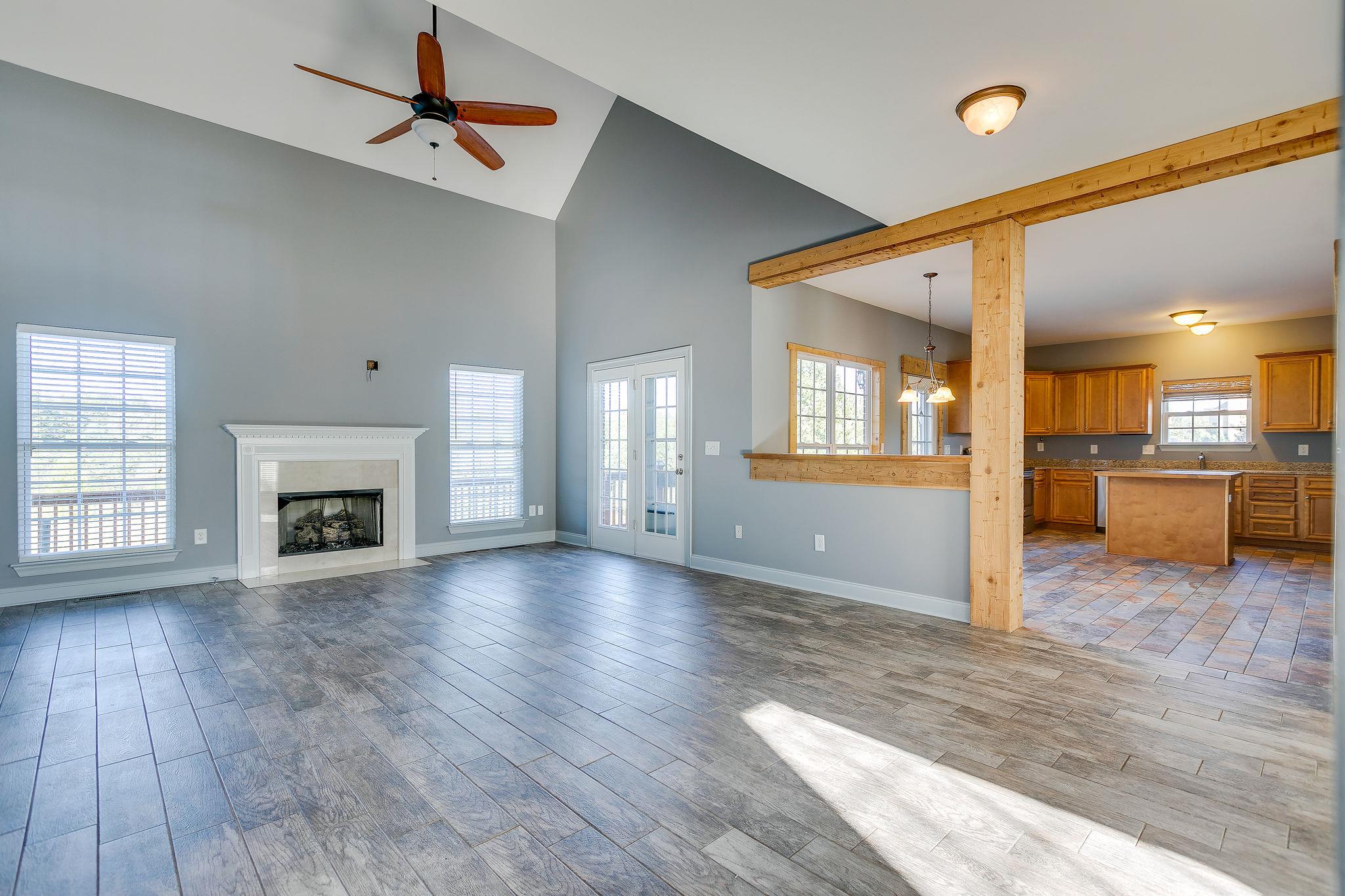 2029 Lincoln Road Spring Hill, TN 37174 - Photo 9 of 30 an empty room with wooden floor a fireplace and windows