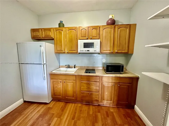 a kitchen with a refrigerator and a microwave