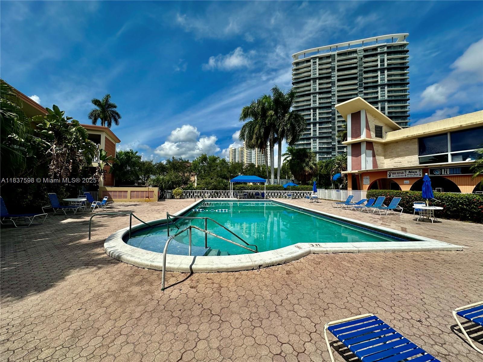 26 Diplomat Parkway, Unit 2368 Hallandale Beach, FL 33009 - Photo 11 of 12 a house view with swimming pool and porch