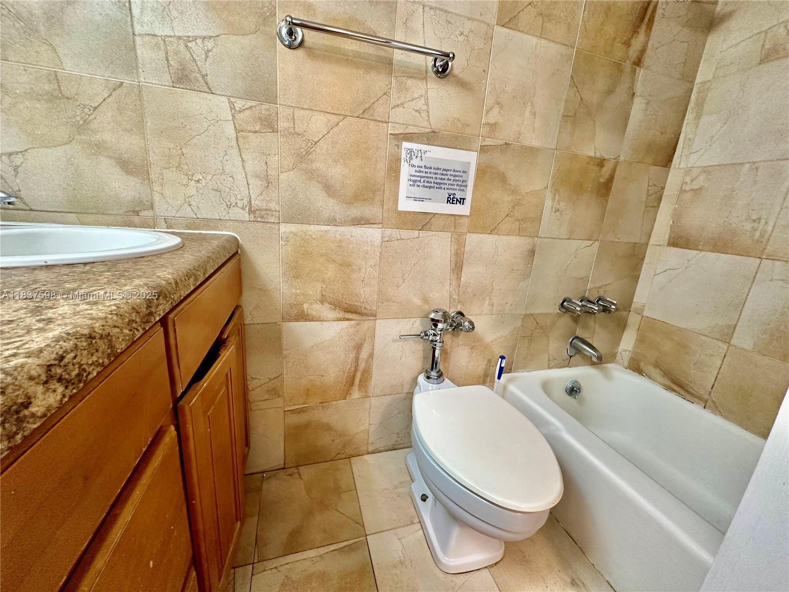 26 Diplomat Parkway, Unit 2368 Hallandale Beach, FL 33009 - Photo 6 of 12 a bathroom with a sink a toilet and shower