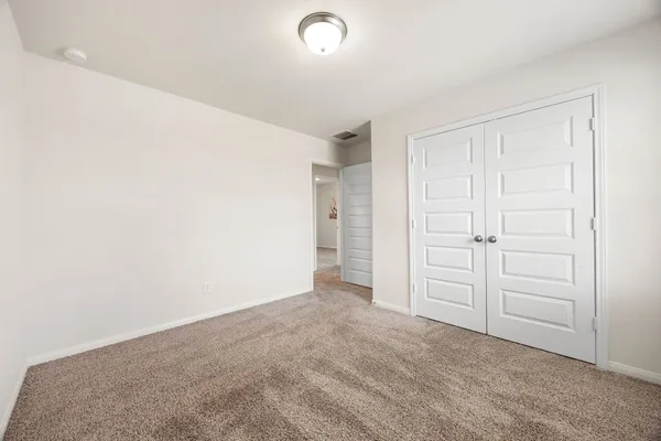 an empty room with closet area