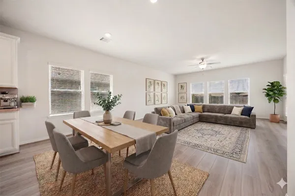 a living room with furniture and wooden floor