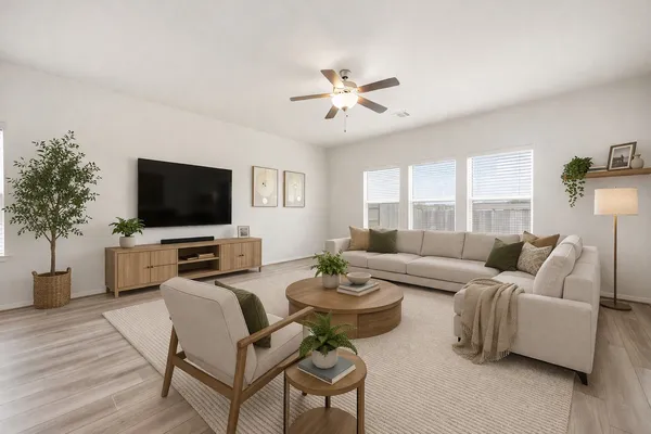 a living room with furniture a flat screen tv and a window