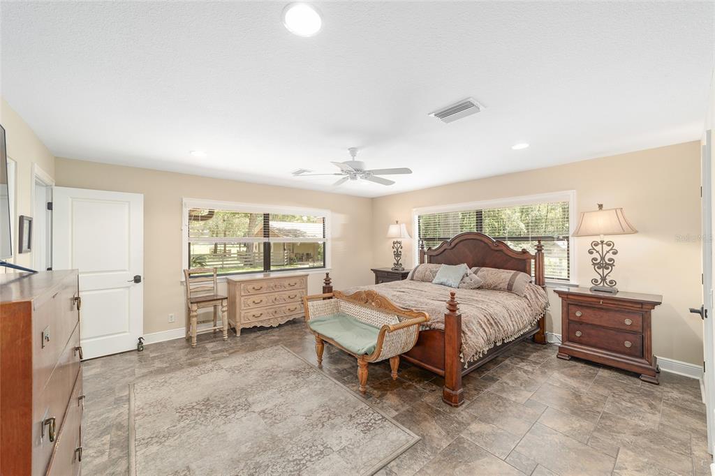 3200 Northeast 97th Street Road Anthony, FL 32617 - Photo 27 of 75 a spacious bedroom with a bed and a large window
