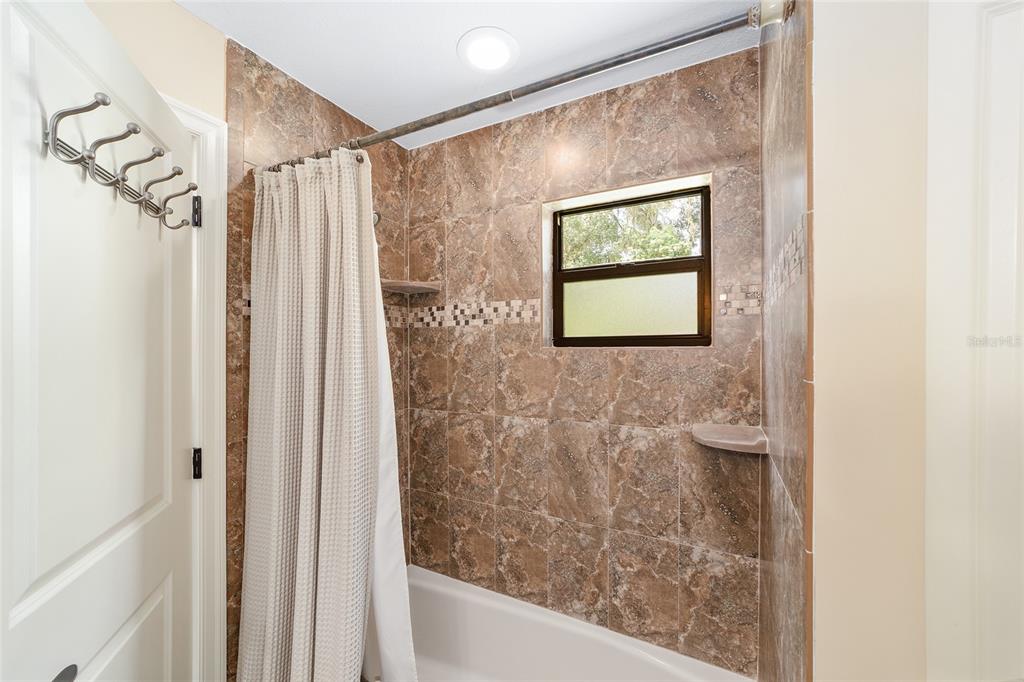 3200 Northeast 97th Street Road Anthony, FL 32617 - Photo 35 of 75 a bathroom with a shower and a sink