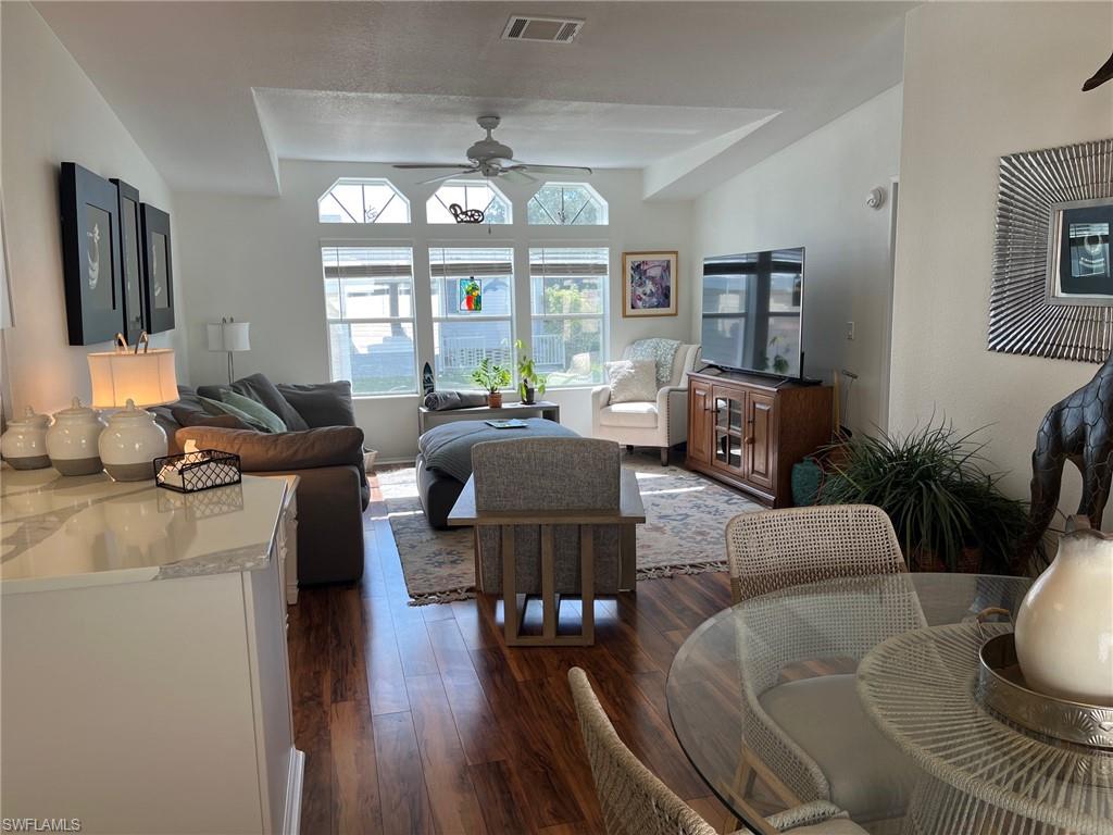 65 Turquoise Avenue, Unit 65T Naples, FL 34114 - Photo 11 of 34 a living room with furniture chandelier and a flat screen tv