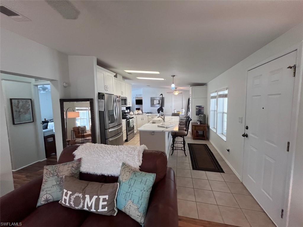 65 Turquoise Avenue, Unit 65T Naples, FL 34114 - Photo 15 of 34 a living room with furniture and view of kitchen
