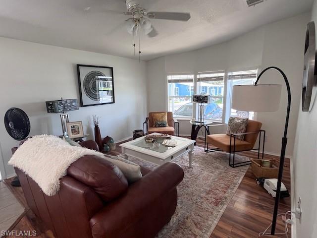 65 Turquoise Avenue, Unit 65T Naples, FL 34114 - Photo 19 of 34 a living room with furniture a window and a chandelier